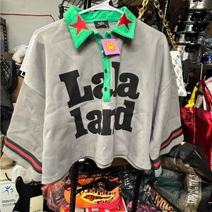 Dressed in LALA Gray Cropped Polo with Green Collar & Red Stars